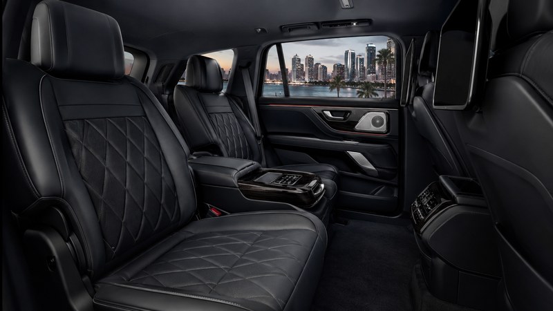 Corporate group boarding black Mercedes Sprinter van at Miami airport